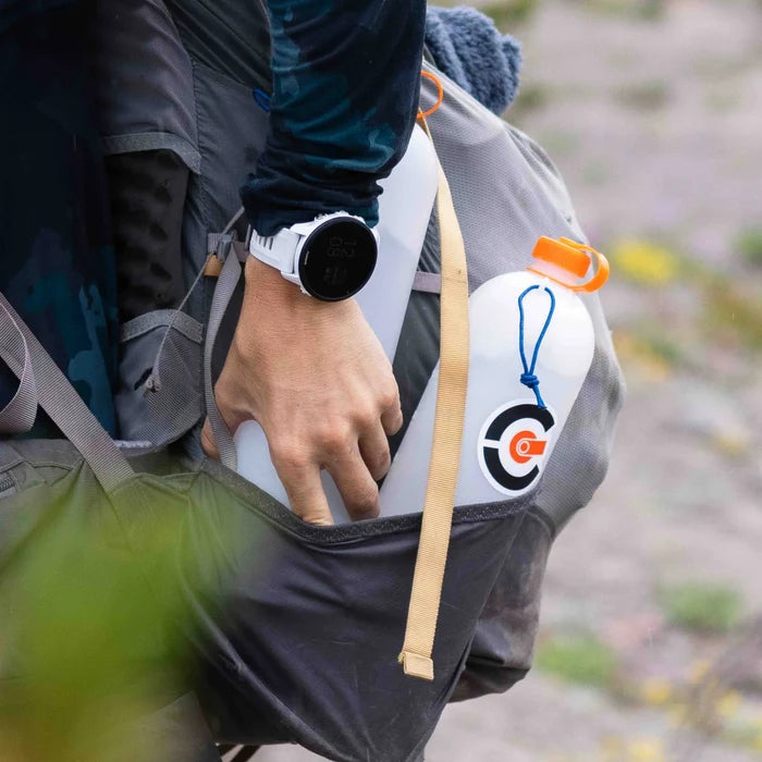 2 thru bottles in the side pocket of a backpack being used in the field.