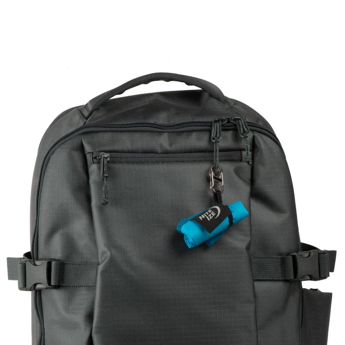 Nite Ize RadDog Bowl Rolled up and clipped onto a backpack with a white background