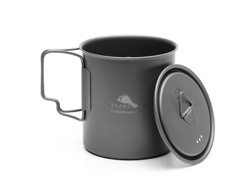 Toaks 450ml cup with the handed open, the lid leaning against the side on a white background