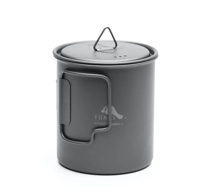 Toaks 450ml cup standing up with the lid on top and the handle folded in on a white background