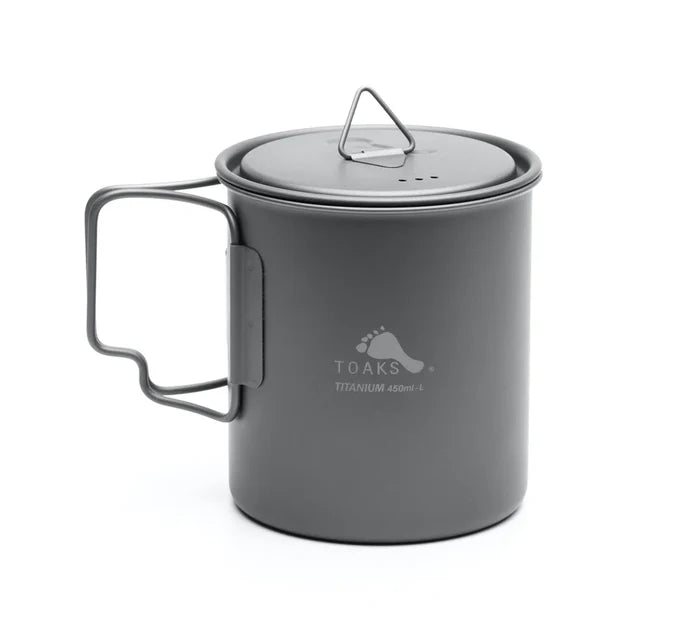 Toaks 450ml cup standing up with the lid on top and the handle out on a white background